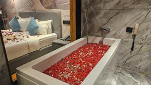 a bathroom with a tub full of red bubbles at Le Sparrow Beach- Rooms in Mangalore
