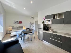 a kitchen and a living room with a table at HOMIA guest house by MOH in Grottaglie +23 photos