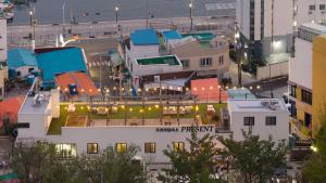 a building with a swimming pool on top of it at Tongyeong Present Gamsung Pension in Tongyeong