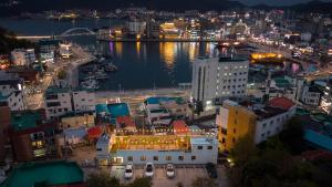 a view of a city at night with a harbor at Tongyeong Present Gamsung Pension in Tongyeong
