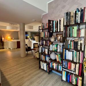 a room with two book shelves filled with books at Hotel Alfieri in Sirmione