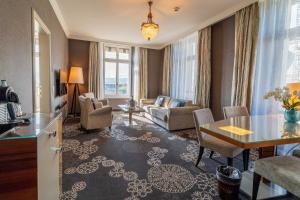 a living room with a couch and a table at Hotel Schweizerhof Luzern in Lucerne
