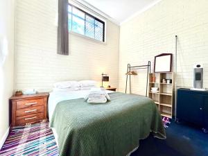 a bedroom with a large bed and a window at Lismore Hillside Home on Ballina Road in Lismore