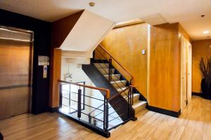 a spiral staircase in a room with a hallway at Windy Ridge Hotel Malate Manila in Manila +16 photos