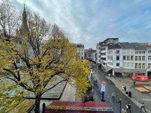 a tree with yellow leaves on a city street at Le Cecil in Liège