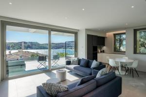 a living room with blue couches and a table at Villa Acquariva Private Heated Pool in Salò