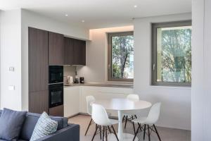 a kitchen and living room with a table and chairs at Villa Acquariva Private Heated Pool in Salò