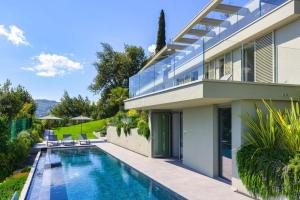 a house with a swimming pool in front of it at Villa Acquariva Private Heated Pool in Salò
