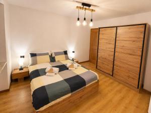 a bedroom with a large bed and two night stands at ElvesHome - Alpine Stay Apartments in Predazzo +8 photos