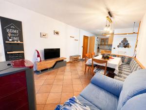 a living room with a couch and a table at ElvesHome - Alpine Stay Apartments in Predazzo