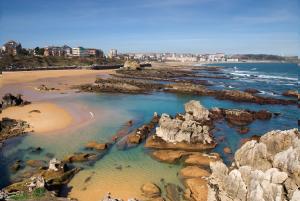 an aerial view of a beach with rocks and the ocean at Apartamentos Las Brisas in Santander