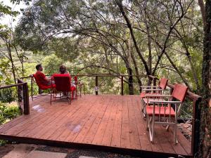 two people sitting in chairs on a wooden deck at Villa Rock Stop Falls Gigiri in Nairobi +56 photos