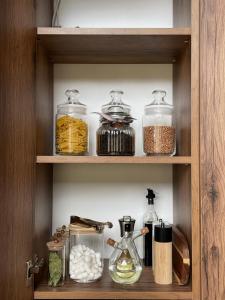 a cabinet filled with glass jars and other food items at Gonta house in Skhidnitsa +8 photos