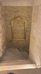 a picture frame hanging on a wall with stairs at Petit cocon à 10min d'Avignon in Pujaut +2 photos