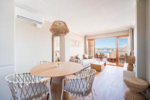 a living room with a table and chairs at CARABELA 94 in Alcudia