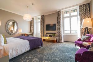 a hotel room with a bed and a tv at Hotel Schweizerhof Luzern in Lucerne +102 photos
