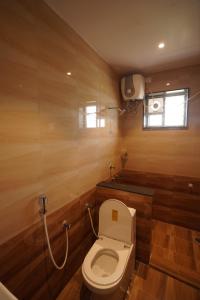 a bathroom with a toilet and a sink at v square inn in Visakhapatnam