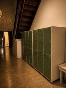 a row of green lockers in a room at Kabalana Surf Hostel in Ahangama