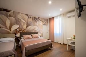 a bedroom with a bed with a flower mural on the wall at Carlo's Luxury Villa in Agerola