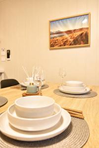 a table with white plates and wine glasses on it at Serene Star in Lake Tekapo +12 photos