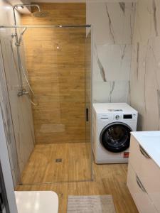 a washer and dryer in a small bathroom at MAAN Apartments in Augustów