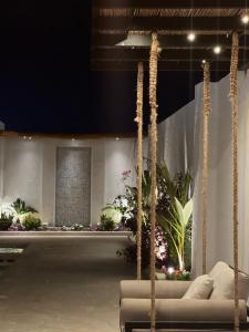 a living room with a couch and some plants at Mykonos Resort in Abu Dhabi