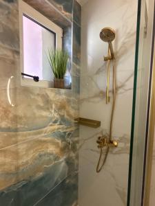 a shower with a glass door with a window at Apartmani Baja in Lopar +120 photos