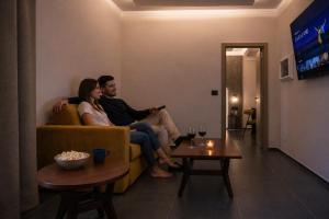 a man and woman sitting on a couch in a living room at Hotel Moderno in Bari