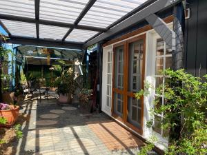 an outdoor patio with a sunvisor over a house at Hidden Gem in the CBD in Coffs Harbour