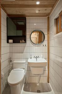 a bathroom with a toilet and a sink at Hanok Moonstay in Gyeongju +42 photos