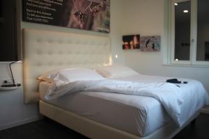 a bedroom with a white bed with a white headboard at Amata Valgre Affittacamere, comfort e pulizia eccezionali!! in Olginate +167 photos