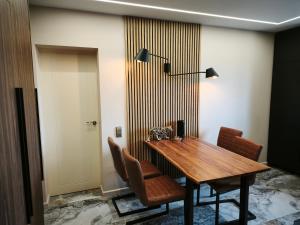 a dining room with a wooden table and chairs at Panorama View Suite in Jelgava
