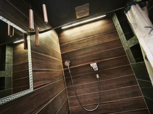 a bathroom with a wooden shower stall with a hose at Panorama View Suite in Jelgava +24 photos