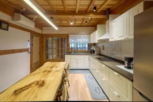a large kitchen with a wooden table in it at Hanok Moonstay in Gyeongju