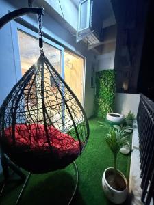 a room with a hammock and a plant at Vetri Homes IV in Zirakpur