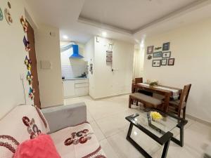 a living room with a couch and a table at Vetri Homes IV in Zirakpur