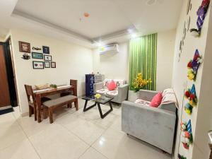 a living room with a couch and a table at Vetri Homes IV in Zirakpur