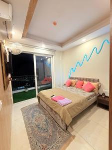 a bedroom with a bed with a blue line on the wall at Vetri Homes IV in Zirakpur