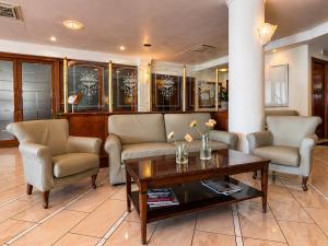 a living room with two chairs and a coffee table at Hotel Valle Rossa in San Giovanni Rotondo +44 photos