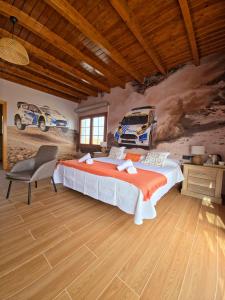 a bedroom with a bed and a painting of cars on the wall at Villa en el Time con piscina in Puerto del Rosario +30 photos