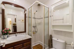 a bathroom with a shower and a toilet and a sink at Las Camelias in Argoños +18 photos