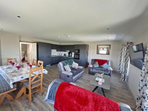 a living room with a table and a dining room at Tigh Fitz Apartments - Inis Mór, Aran Island in Inis Mor