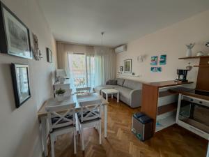 a living room with a table and a couch at Jellyfish in Malinska