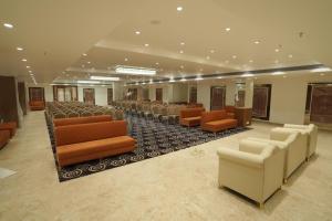 a conference room with a row of chairs and tables at The Grand Icon in Chandrapur