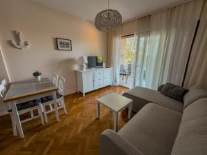 a living room with a couch and a table at Jellyfish in Malinska