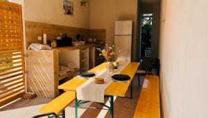 a dining room with a table and a refrigerator at Casa de Oaspeti 2 Mai in 2 Mai +22 photos
