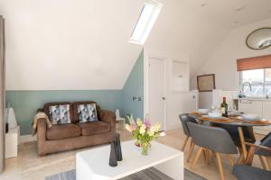 a living room with a couch and a table at York House in Aldeburgh