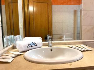 a bathroom counter with a sink and a mirror at AC Apartaments Canillo in Canillo +10 photos