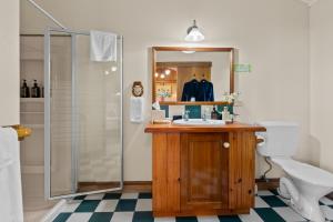 a bathroom with a sink and a shower at Tamborine Mountain Bed and Breakfast in Mount Tamborine +47 photos