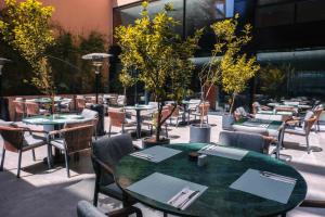 a restaurant with tables and chairs and trees at Longue vie Hotels in Marrakesh